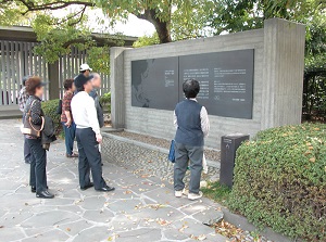 Visitors reading explanation board