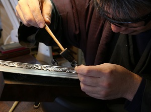 Work of carving on Japanese sword